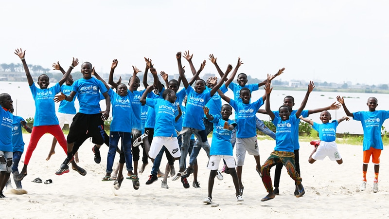 Children wearing Unicef t-shirts jumping