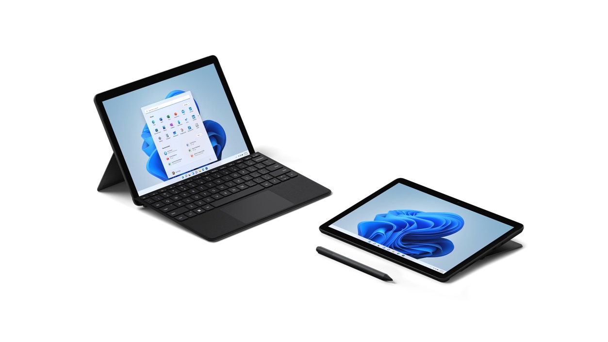 A Surface Go 3, shown in Laptop Mode with a Surface Type Cover and a Surface Go 3, shown in Studio Mode beside a digital pen.