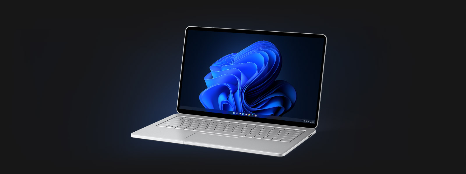 A laptop displaying the Windows 11 bloom desktop background screen