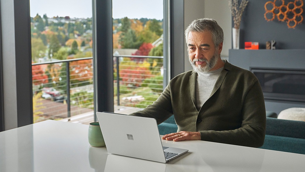 A person finds quiet focus while working with Surface Laptop Go 2 for Business.