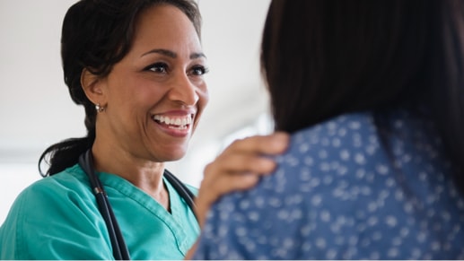 Un professionnel de la santé en train de sourire à un patient.