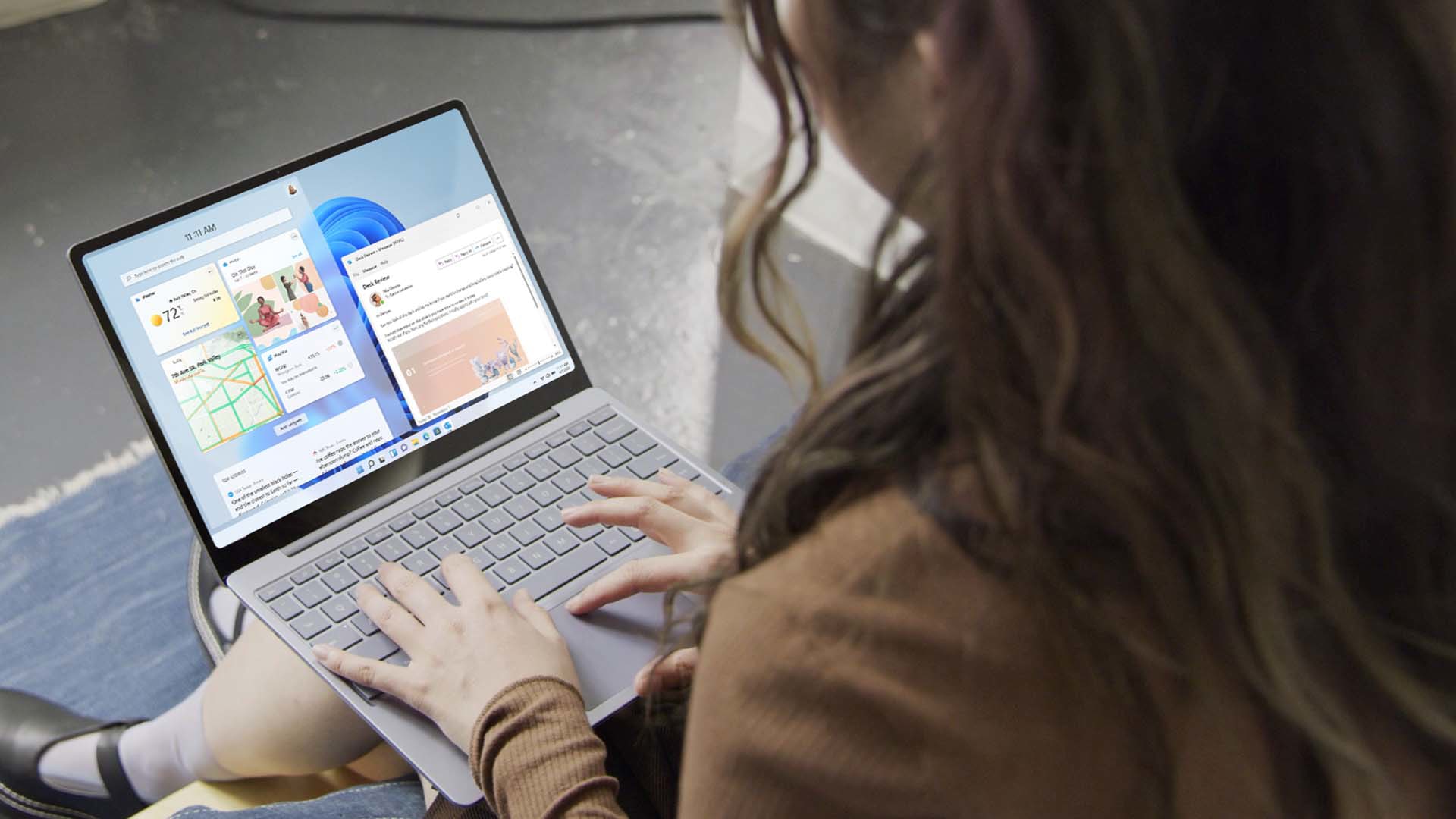 A woman uses Windows 11 on her Surface Laptop Go 2.