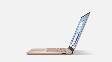 A side view of Surface Laptop Go 2 in Sandstone focused on the thinness of the device.