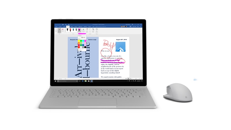 Surface Precision Mouse next to a Surface Book 2 running Word
