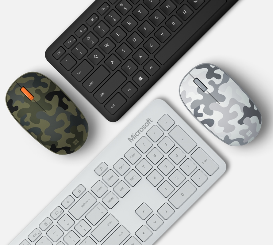 Microsoft Microsoft Bluetooth Mouse Camo Special Edition next to keyboards.