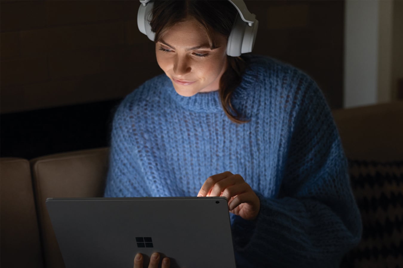 A woman listens to a film with headphones